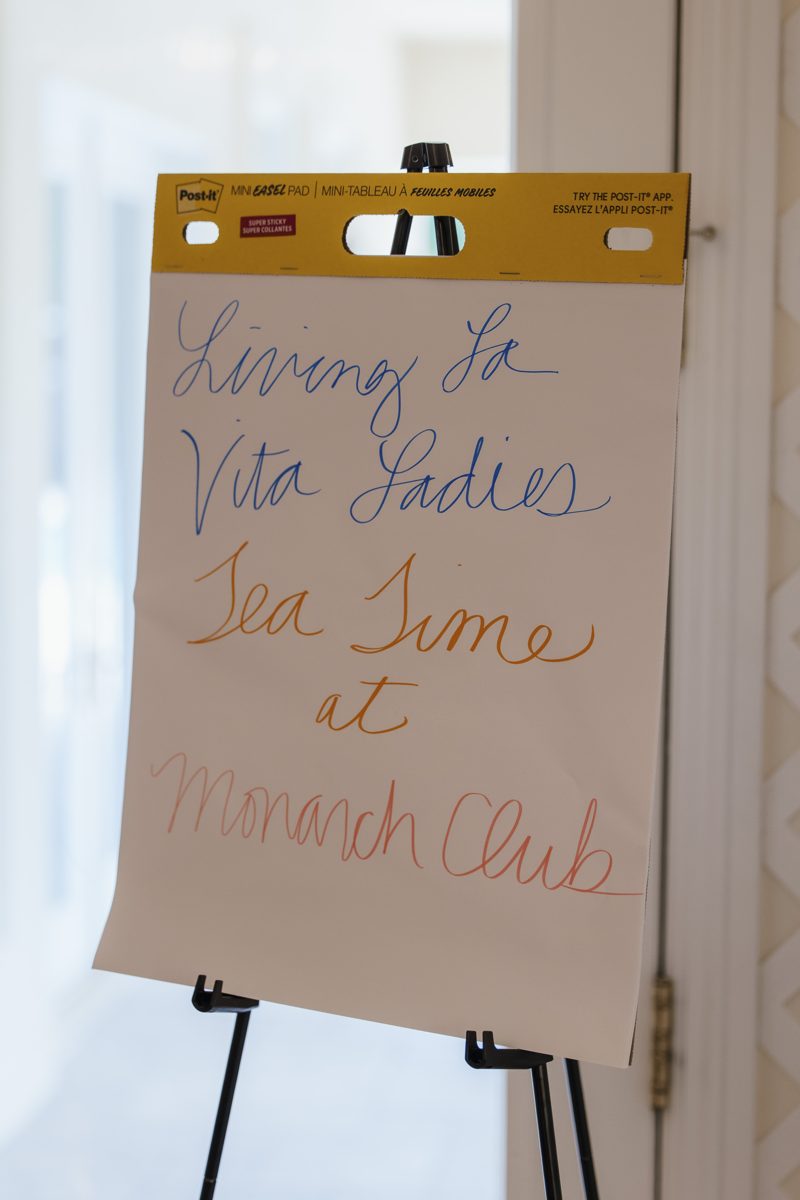 Handwritten welcome sign for Living La Vita Ladies Tea Time at Monarch Club